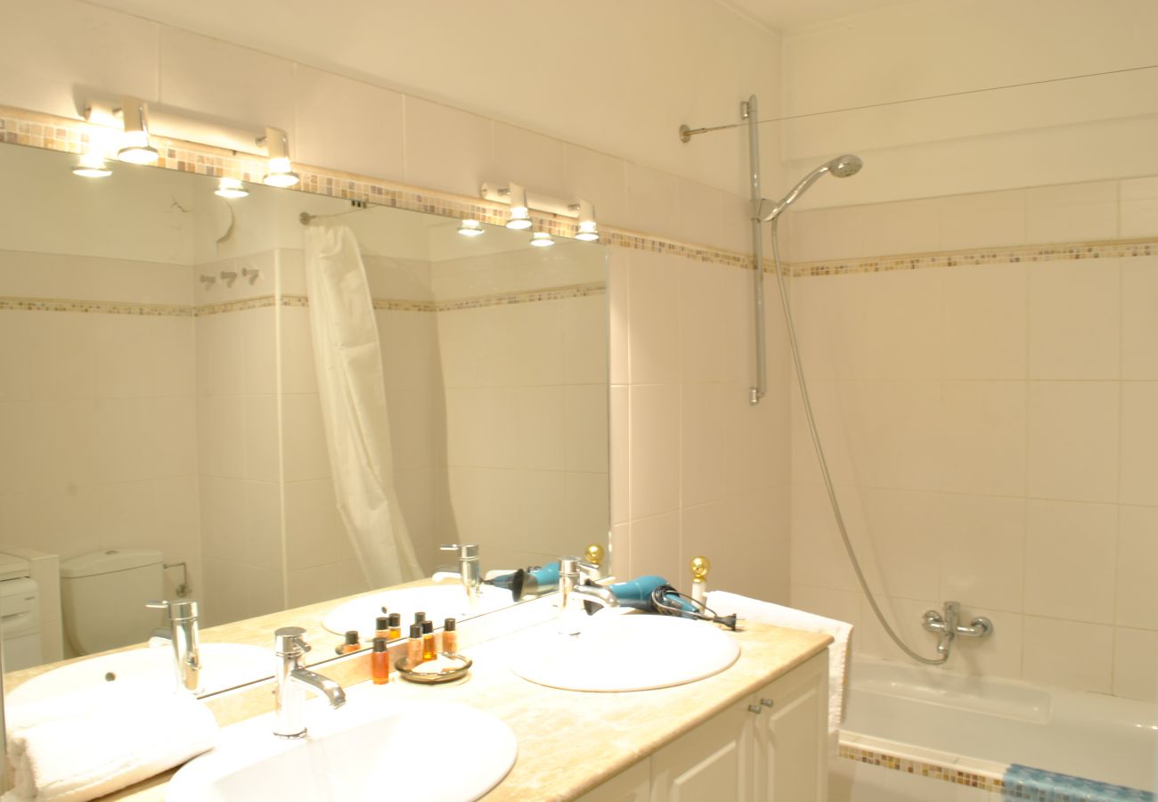 bathroom with marble bathtub