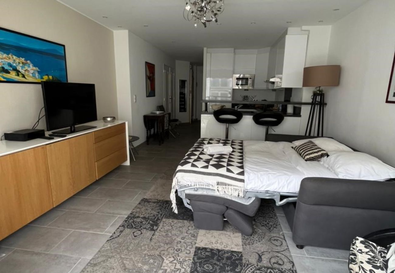 Functional living room with sofa bed and designer furniture