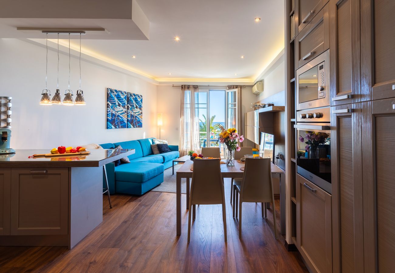 Living room with open kitchen, modern decor, and lovely views. Perfect for relaxing and socializing.